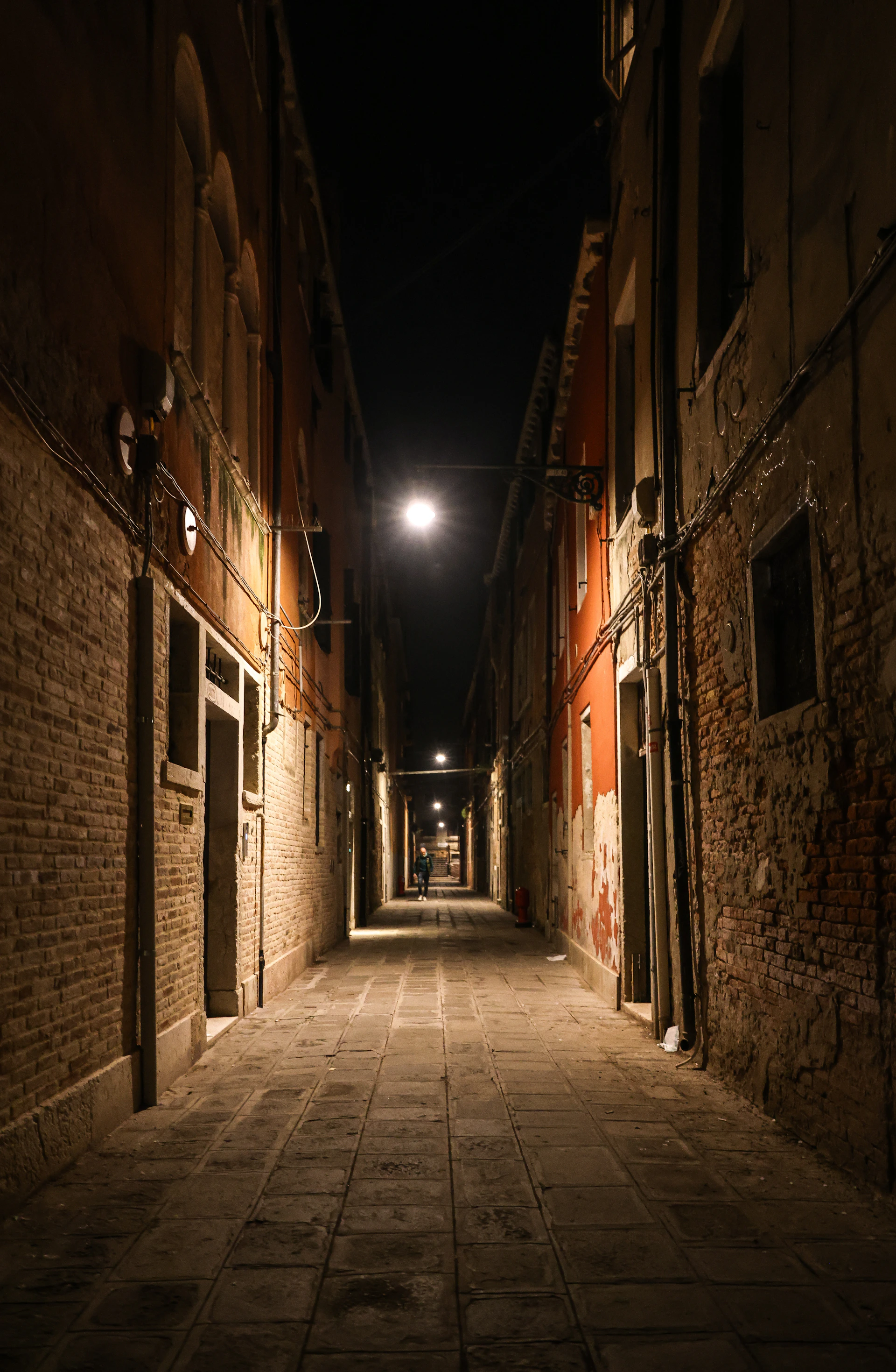 Narrow alleyway in venice at night.