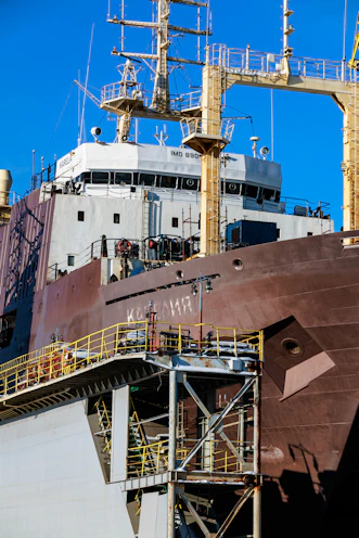 Large cargo ship with detailed superstructure and industrial structure.