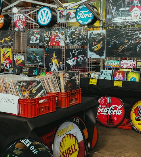 Records and vintage signs displayed at a market