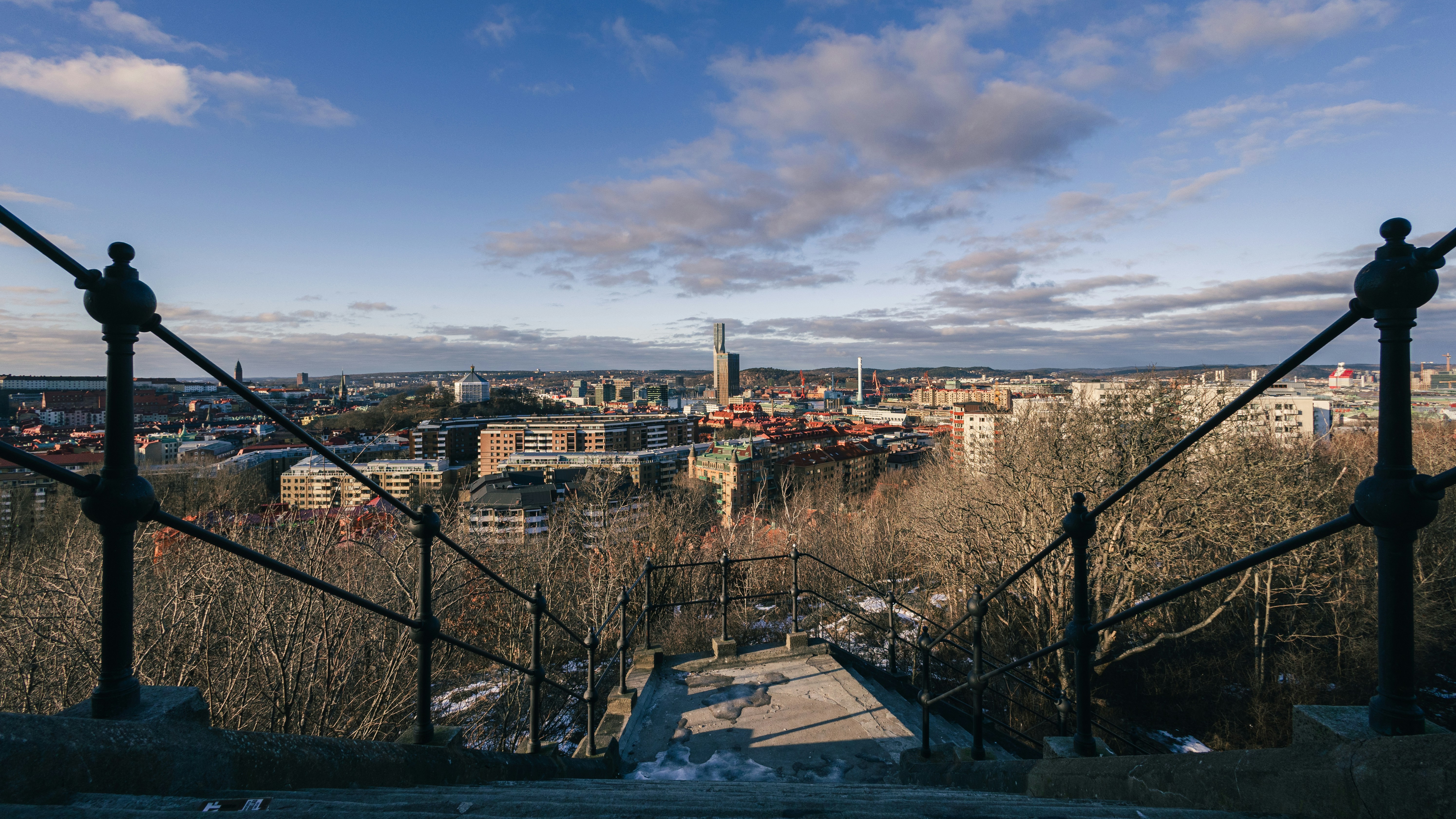 City skyline viewed through ornate railing on a clear day