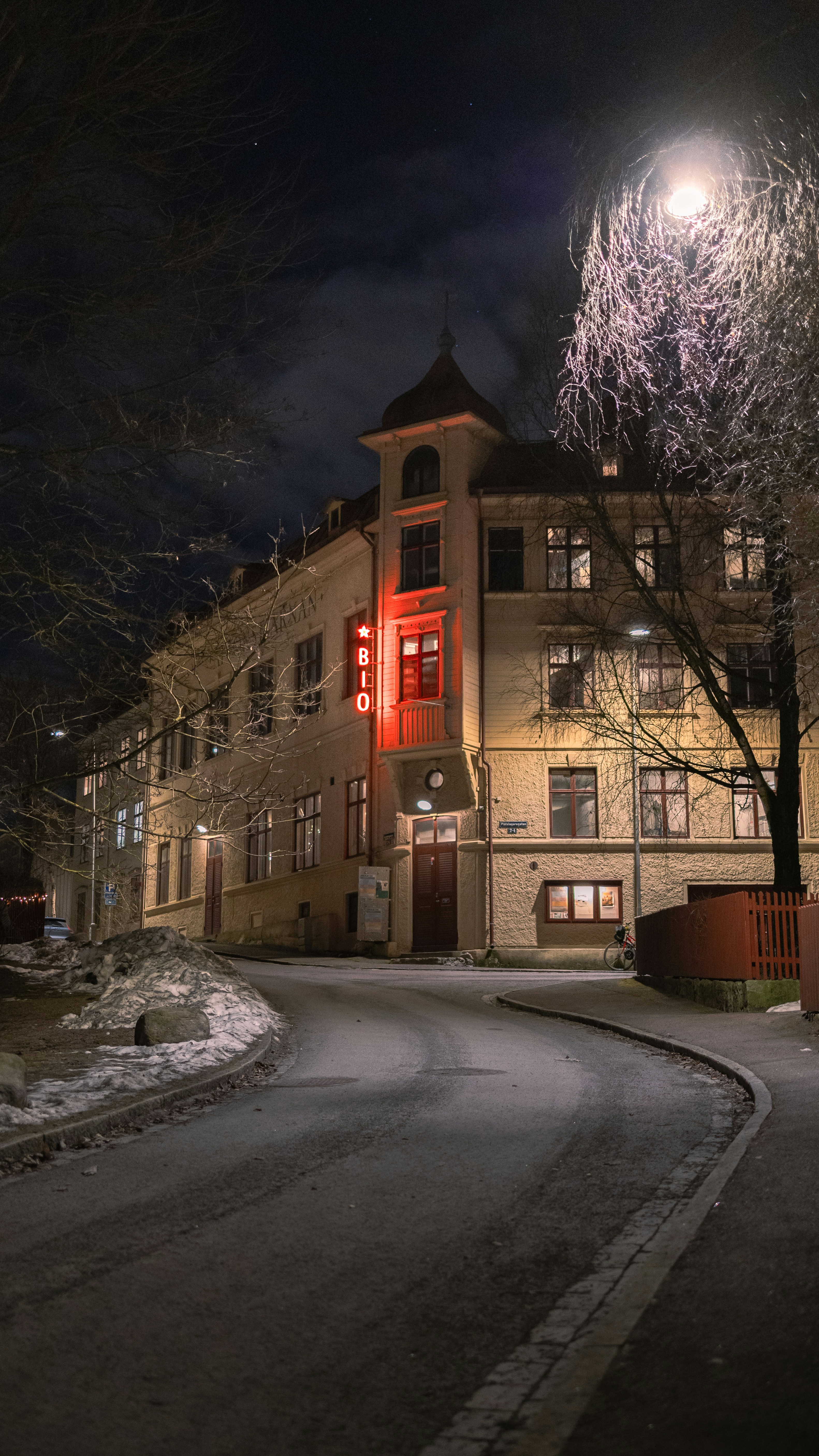 Building with red neon sign at night