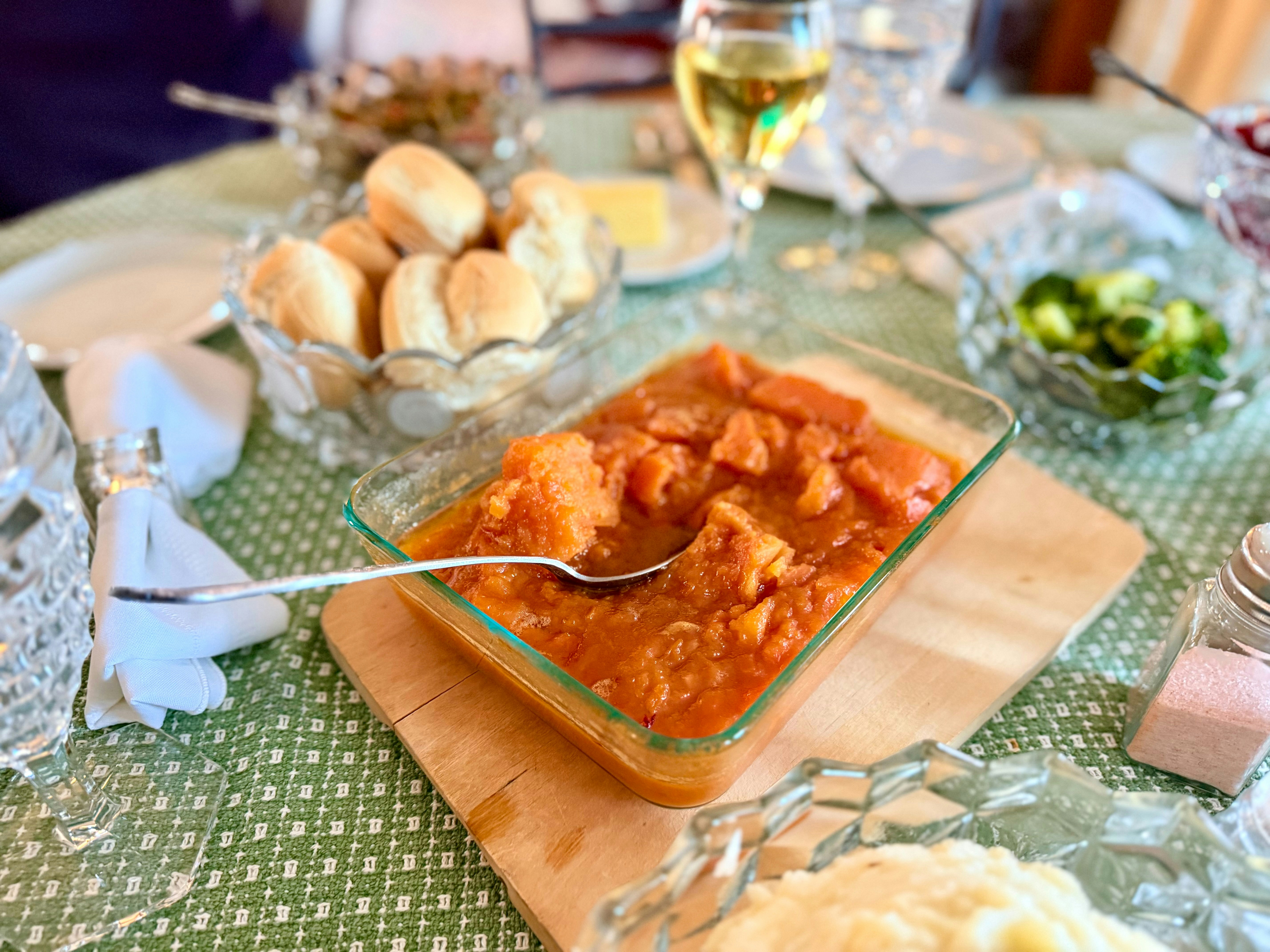 A thanksgiving dinner table with various dishes.
