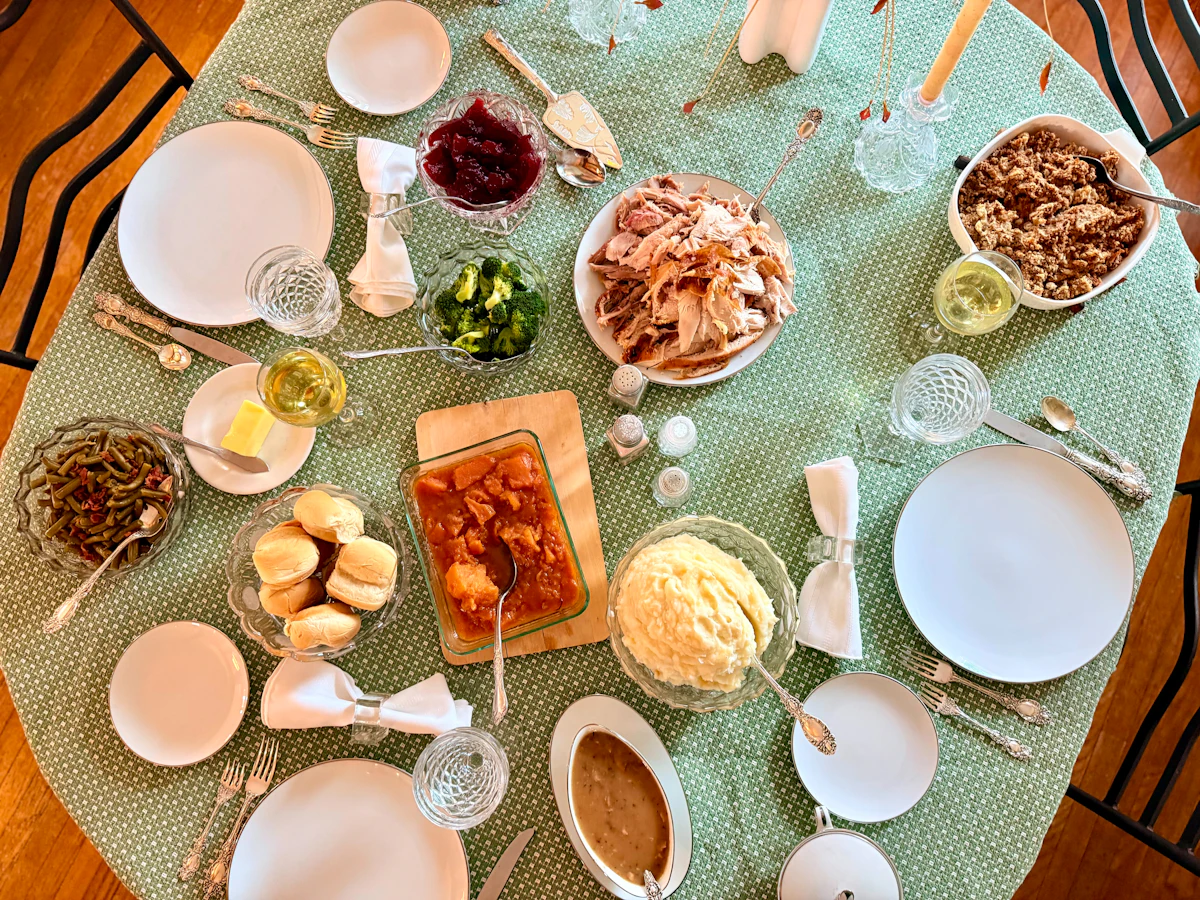 A homestyle spread of home-cooked dishes laid out on a family dining table