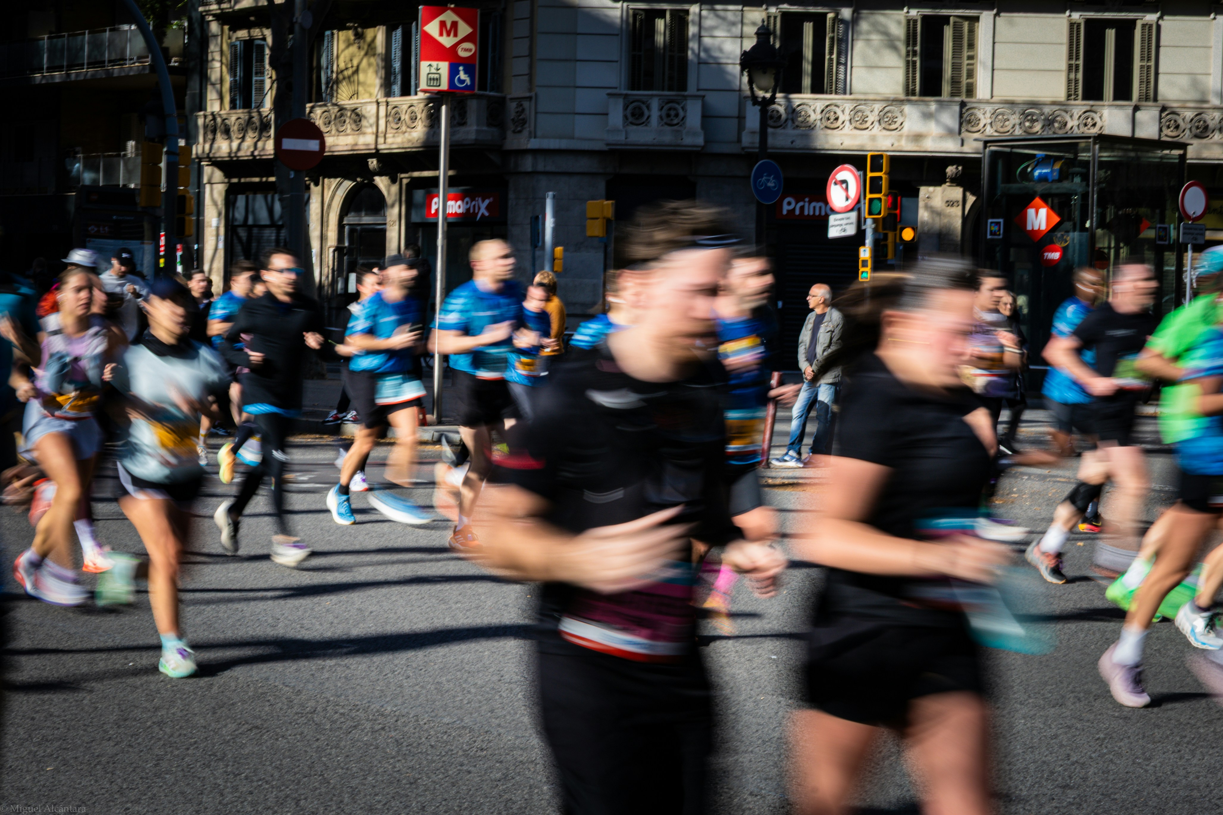 Runners in a marathon race on a city street.