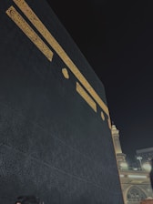 The kaaba in mecca at night with golden trim
