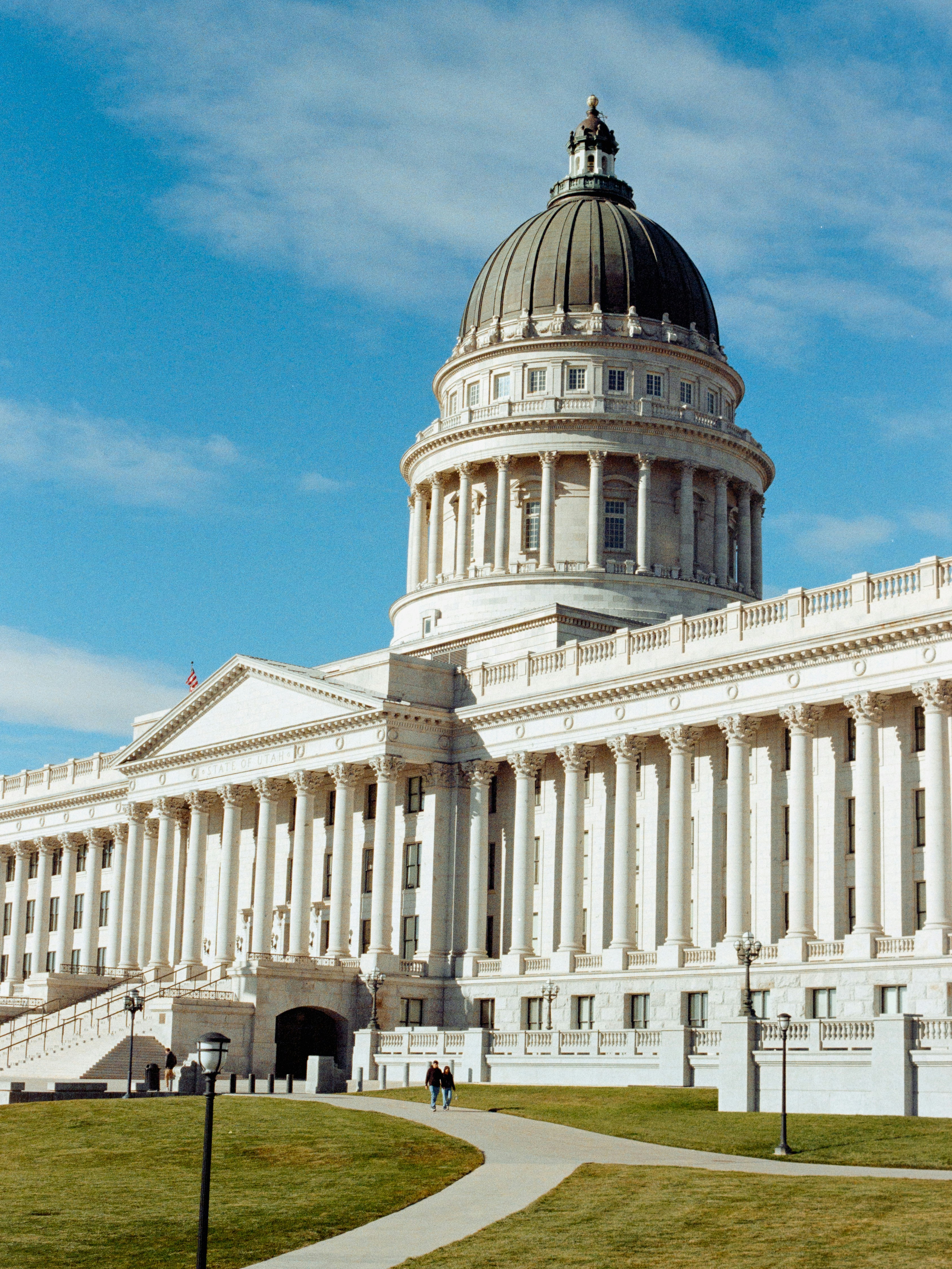 Grand white building with a dome under a blue sky