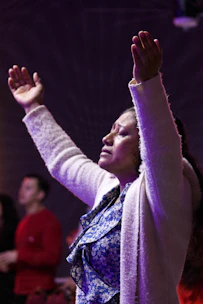 Woman with arms raised in prayer