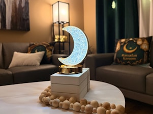 Crescent moon decoration on table with sofas behind sofas