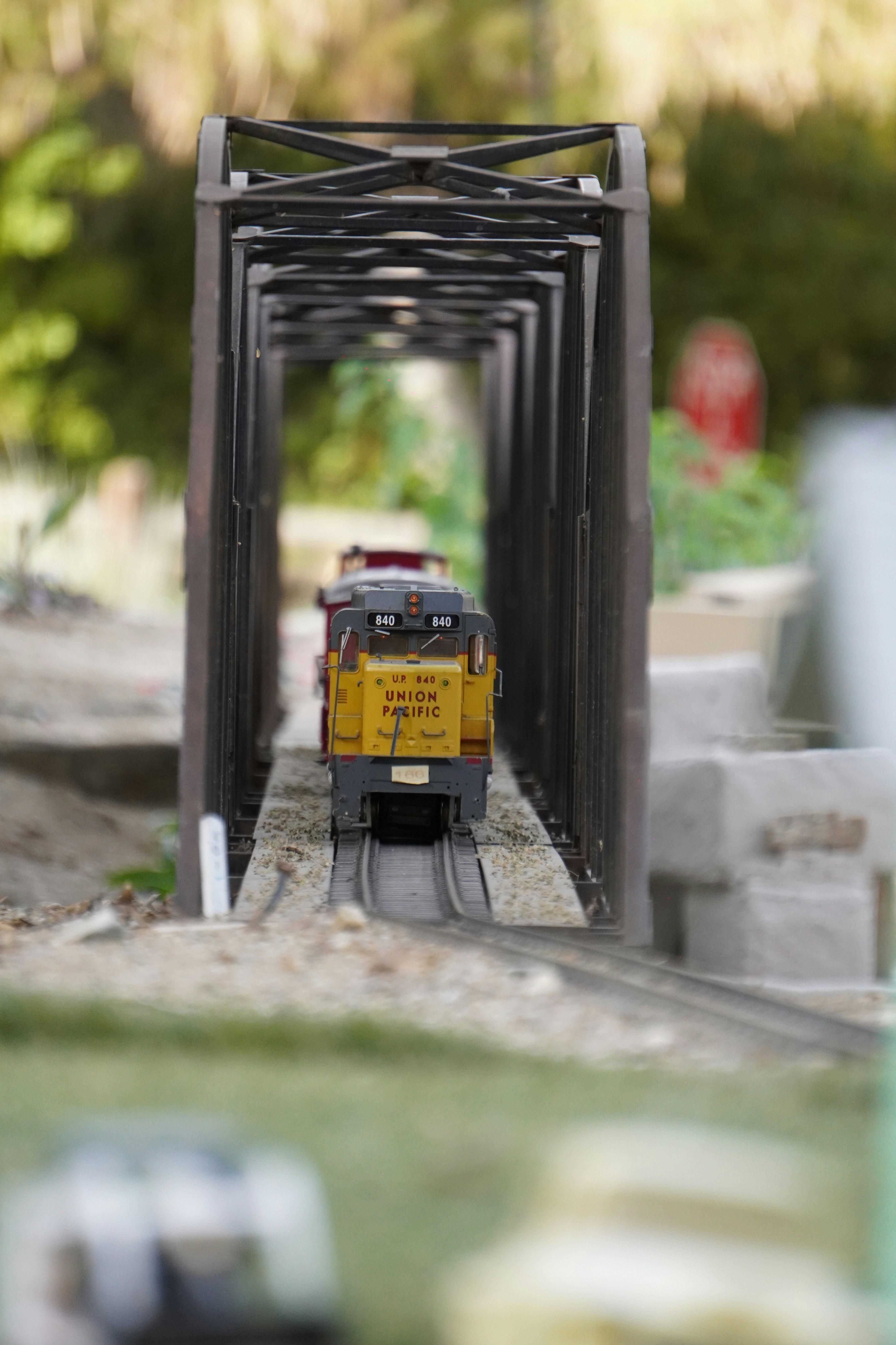 Model train engine crossing a miniature bridge