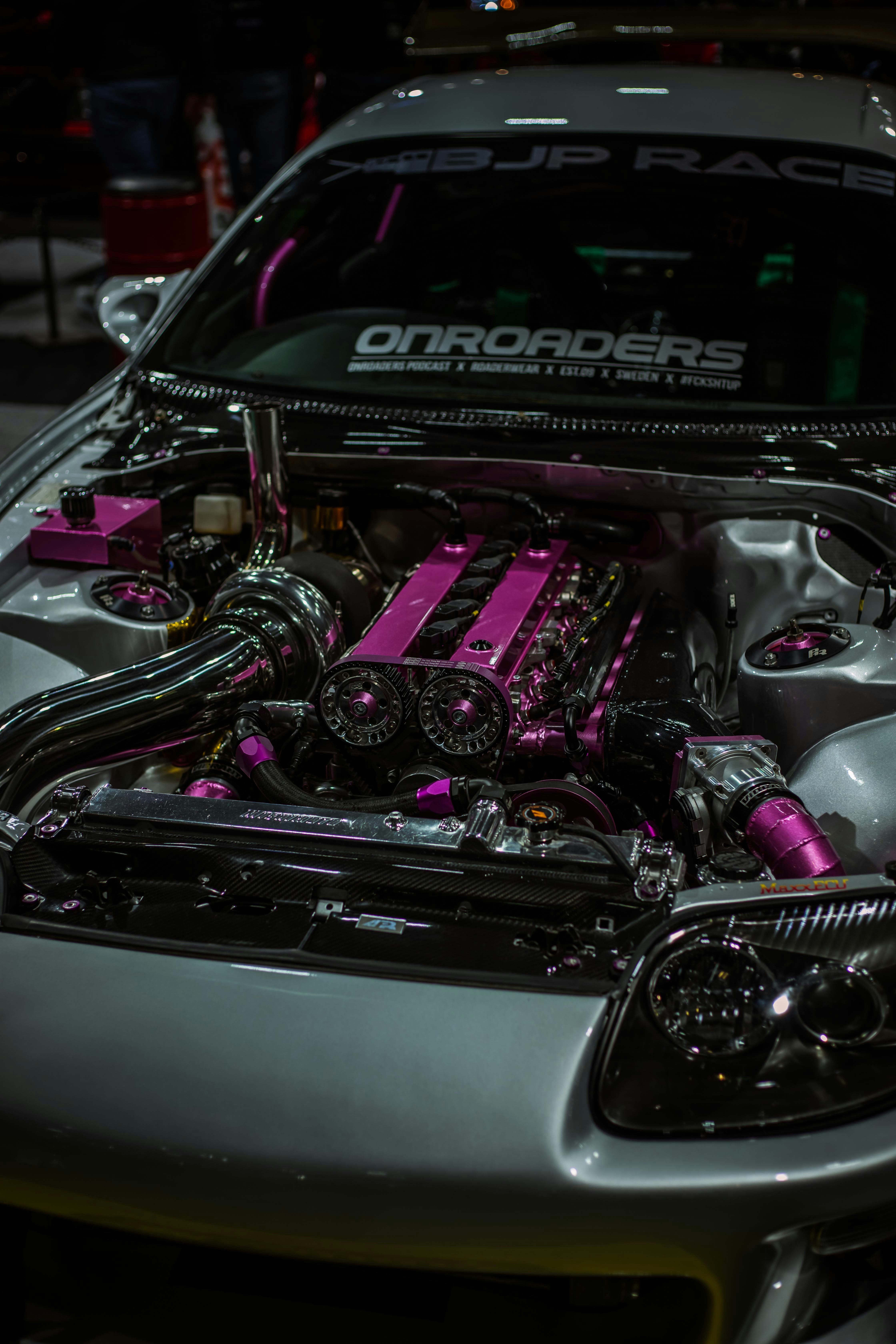 Customized engine bay with pink accents and chrome details