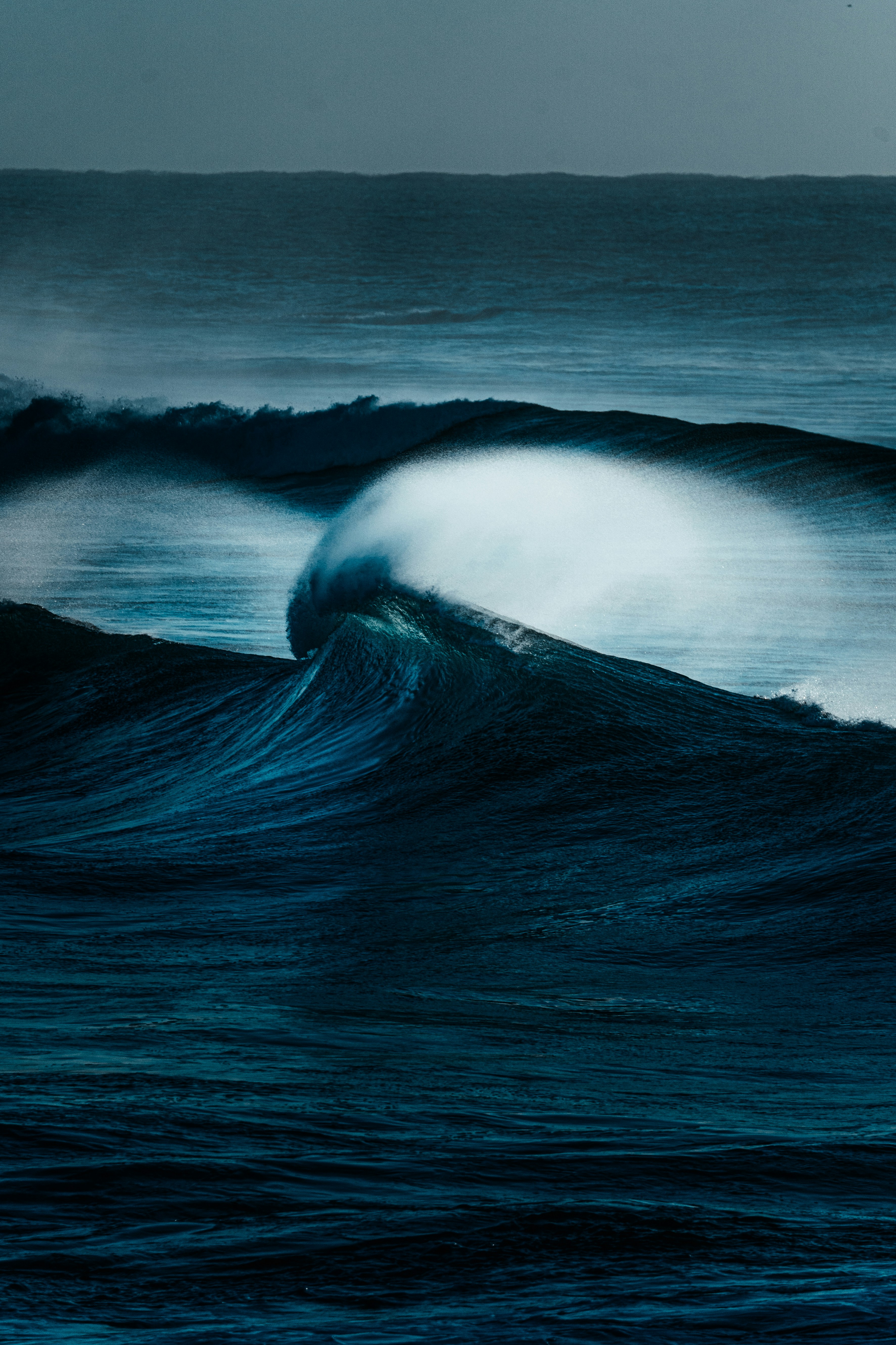 Crashing ocean waves under a dark sky