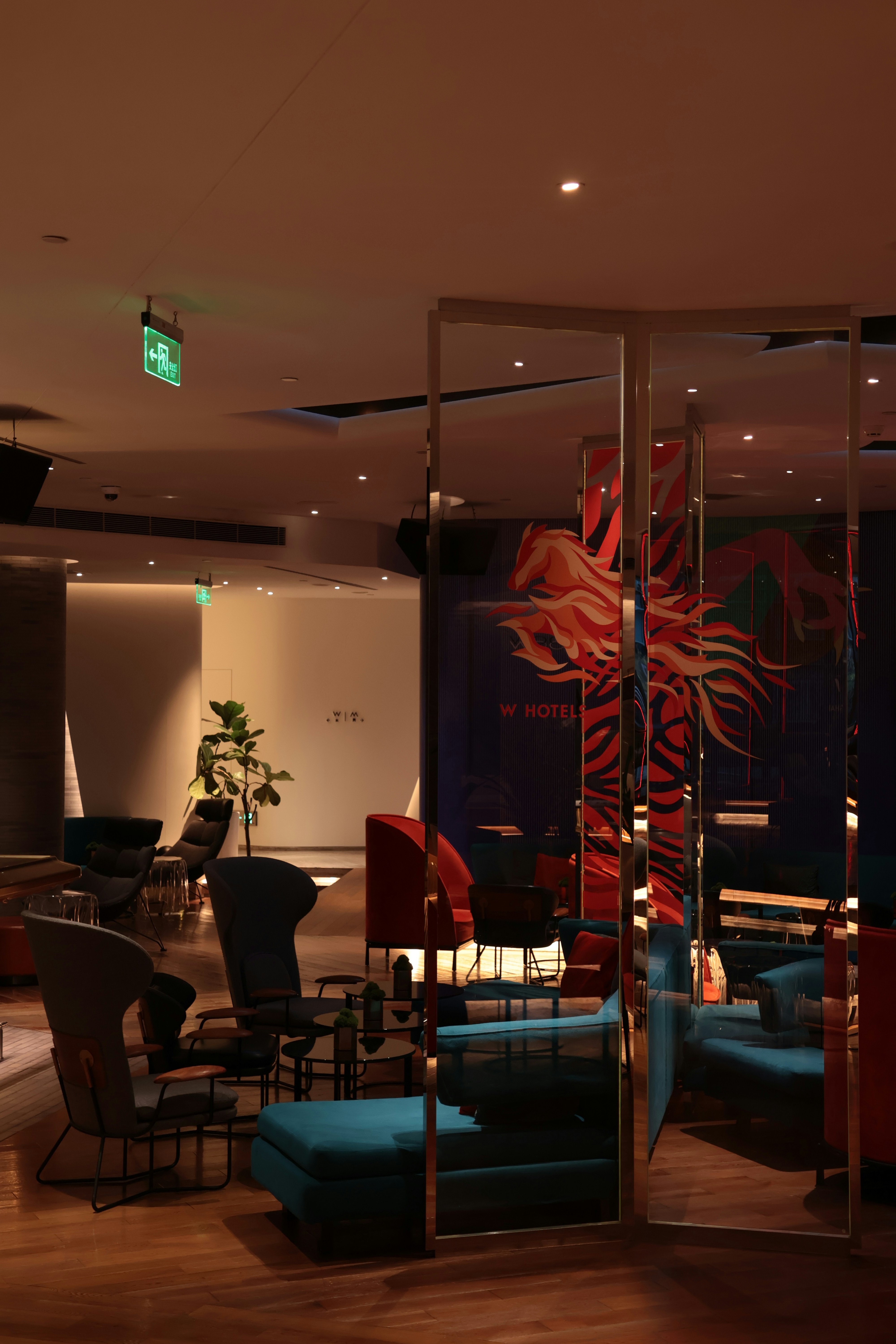 Modern lounge area with colorful seating and mirrors