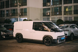 A white delivery van parked at night.