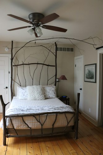 A welcoming living room set up with fresh towels, a throw blanket, and warm lighting