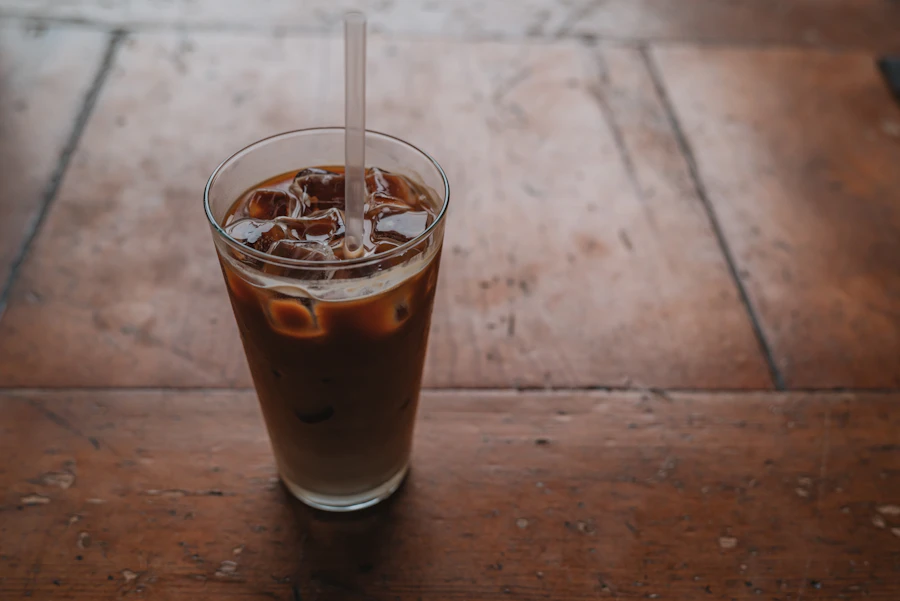Iced coffee with cream and a straw