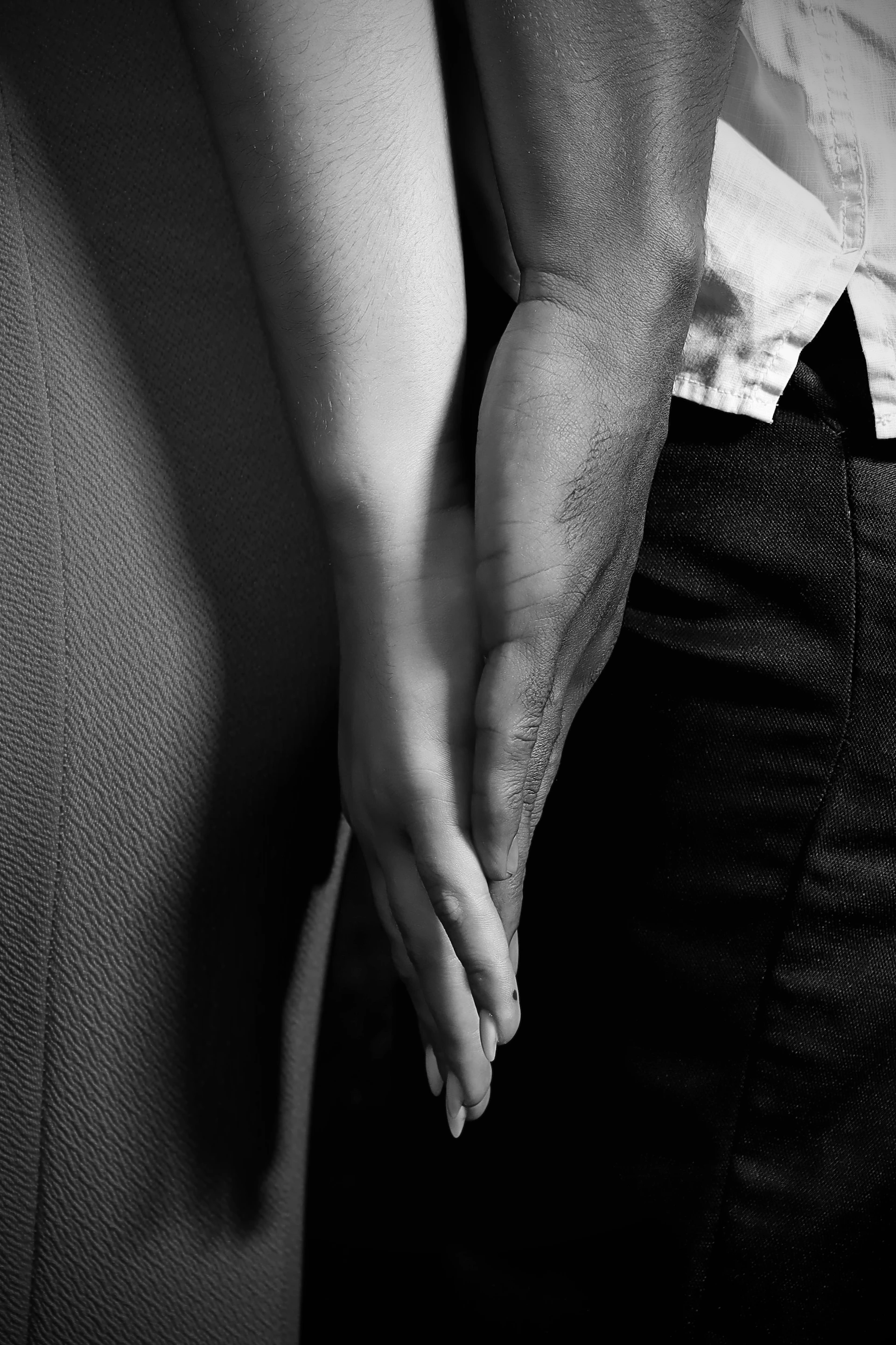 A couple holding hands in black and white.