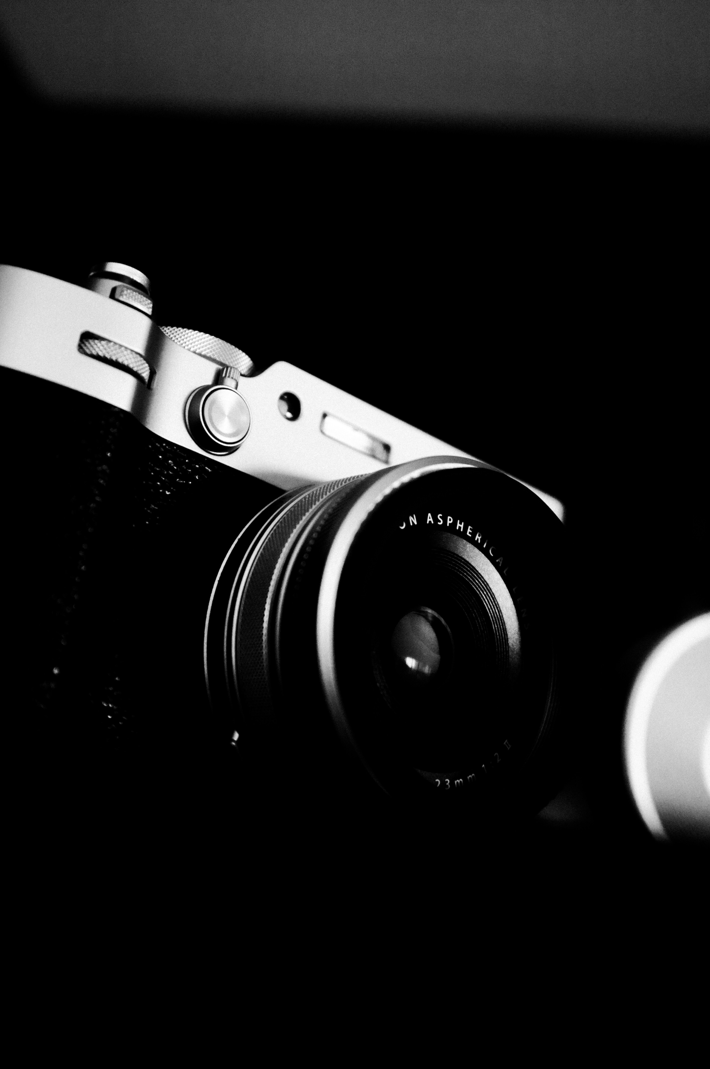 A black and white close-up of a vintage camera