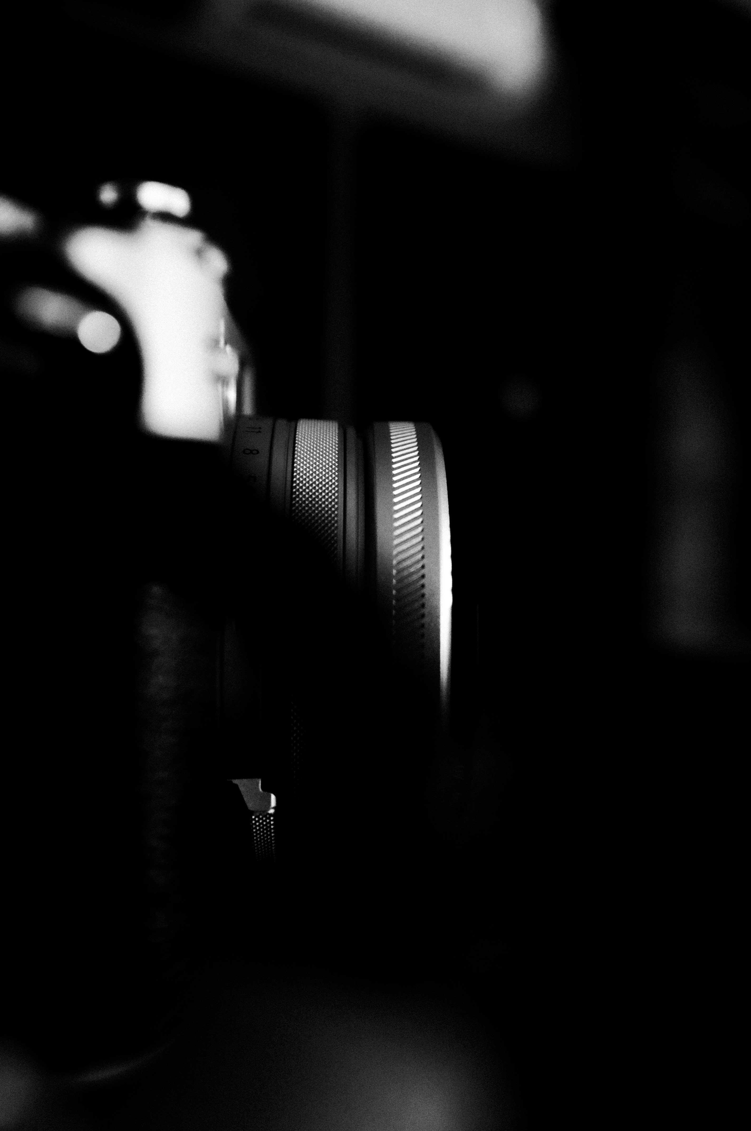 Close-up of a camera lens in shadow