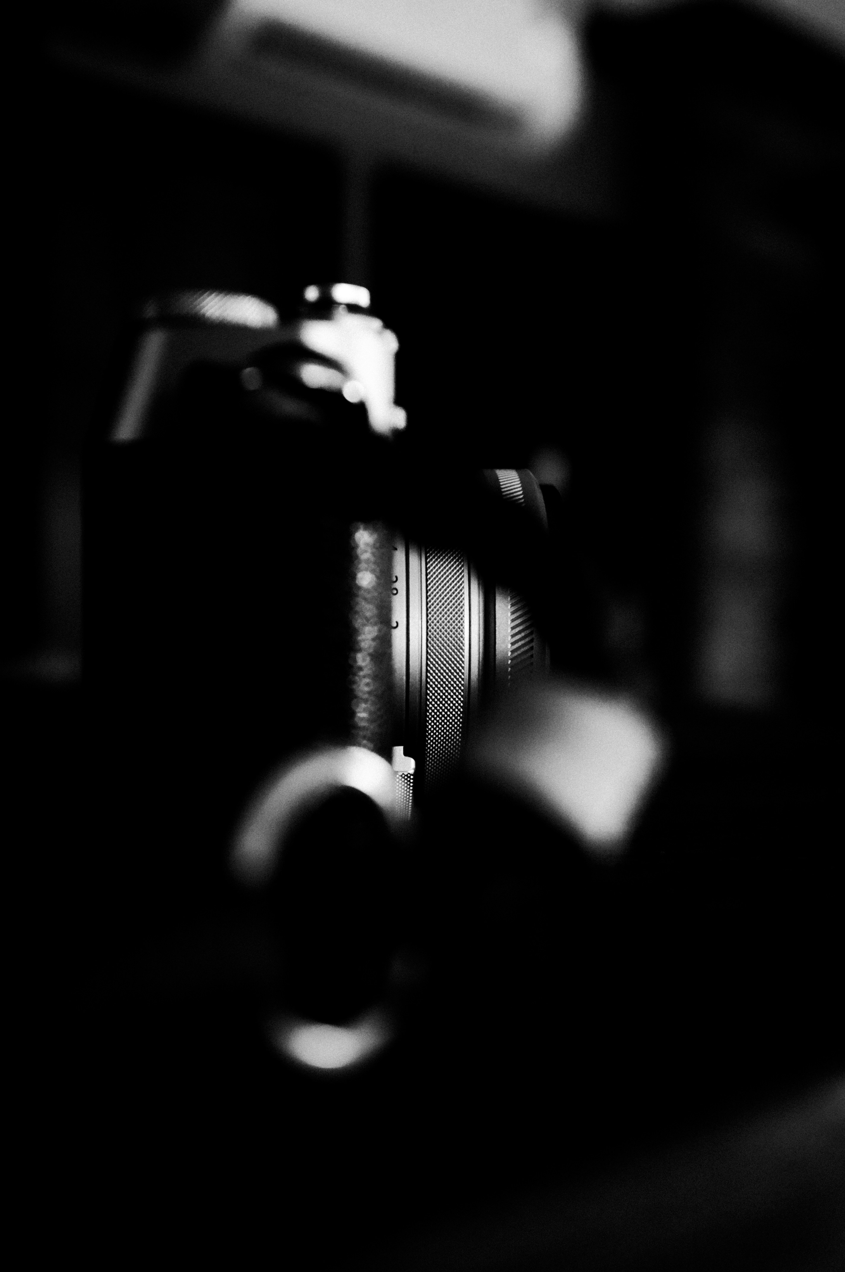 Close-up of vintage camera lens in black and white.