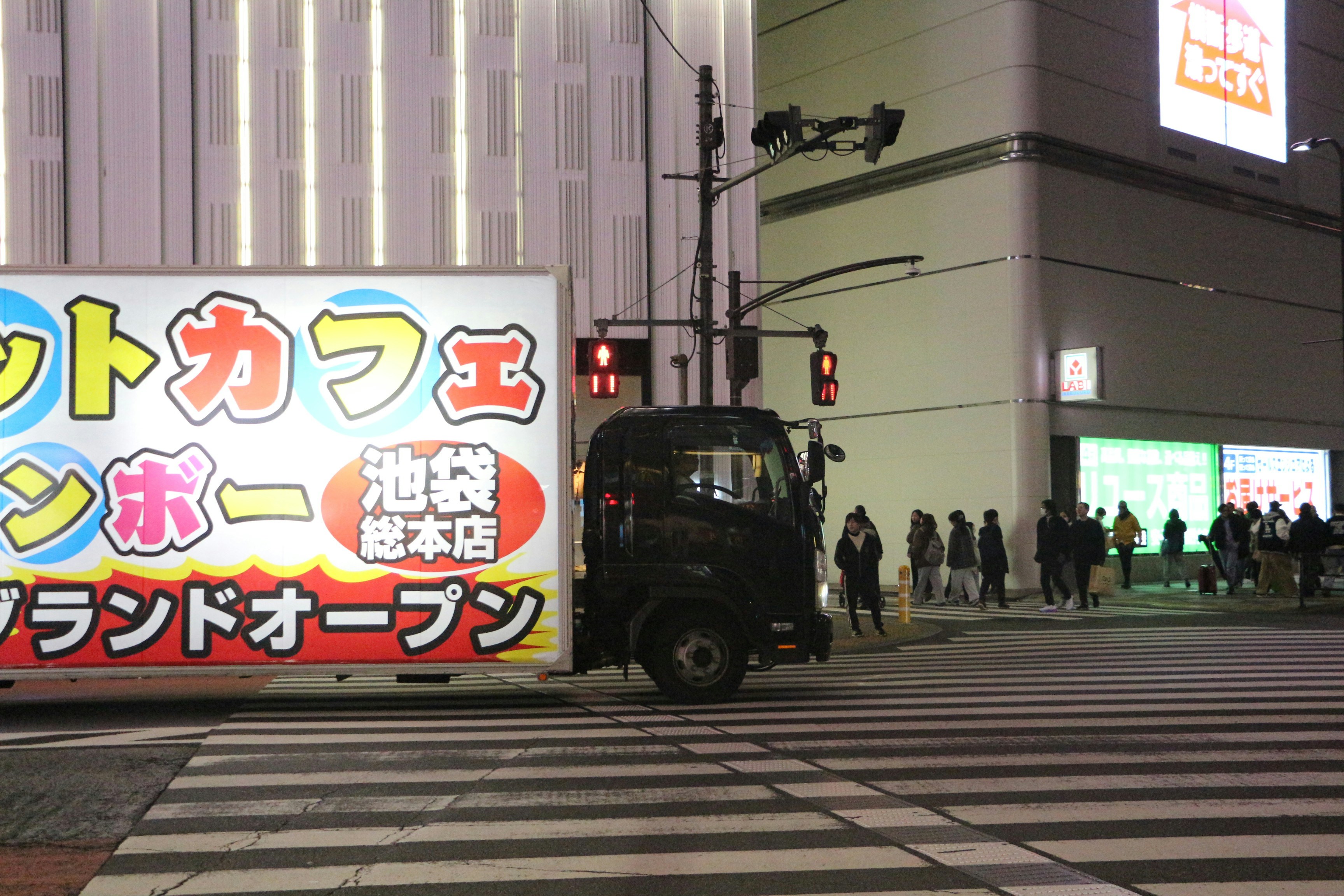 Truck with japanese text drives through city intersection