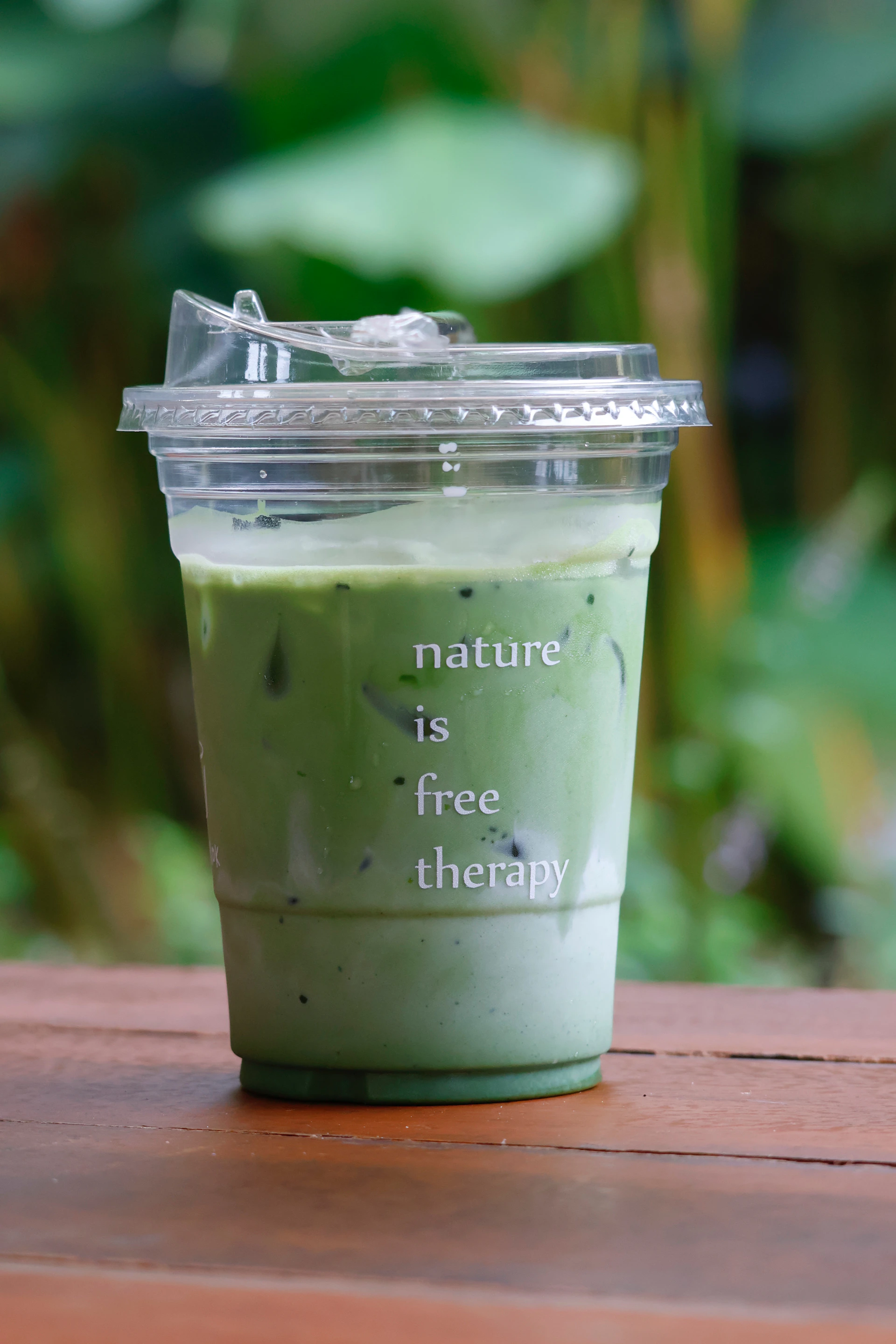 Iced matcha latte with text on cup