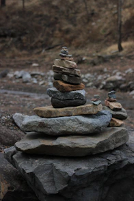 Stacked stones form a balanced cairn in a natural setting.