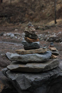 Stacked stones form a balanced cairn in a natural setting.