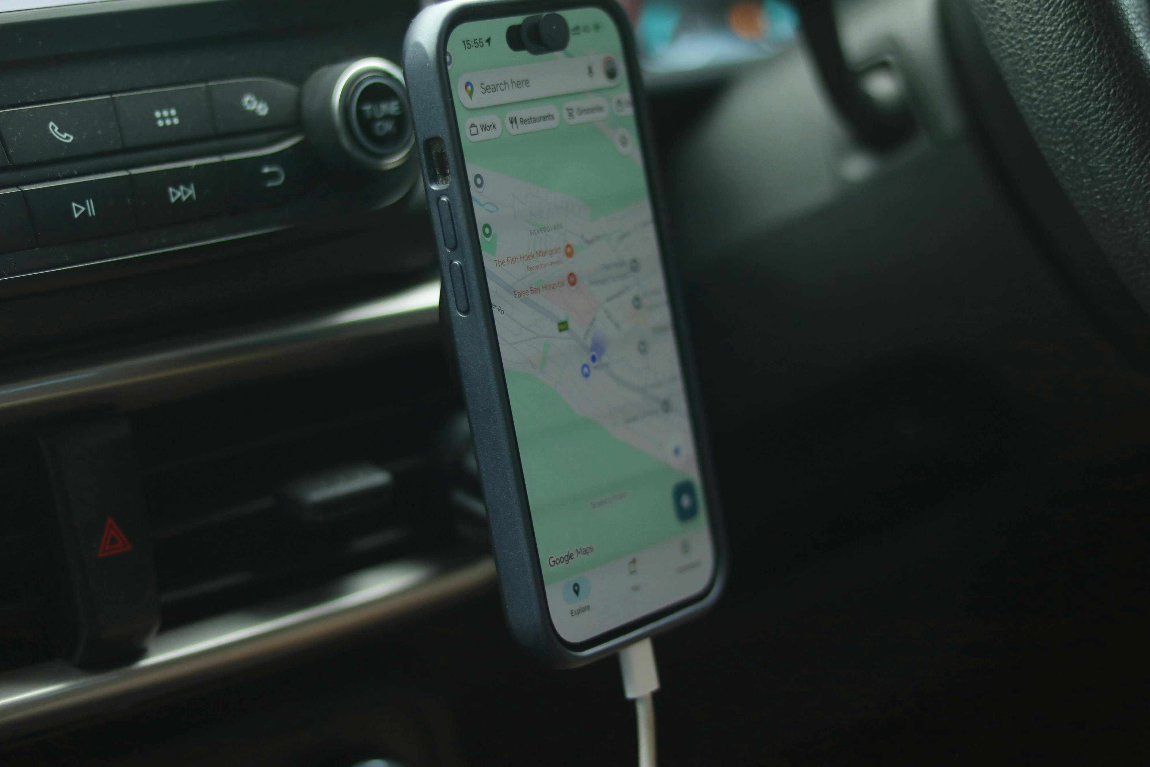 close up shot of smartphones displaying digital barcode discount pass inside automobile interior