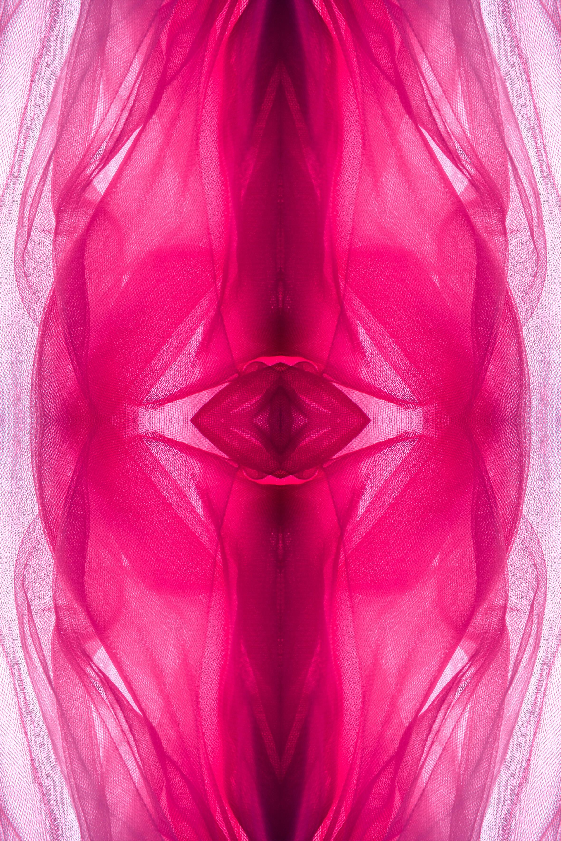 Abstract flowing pink fabric with symmetrical patterns