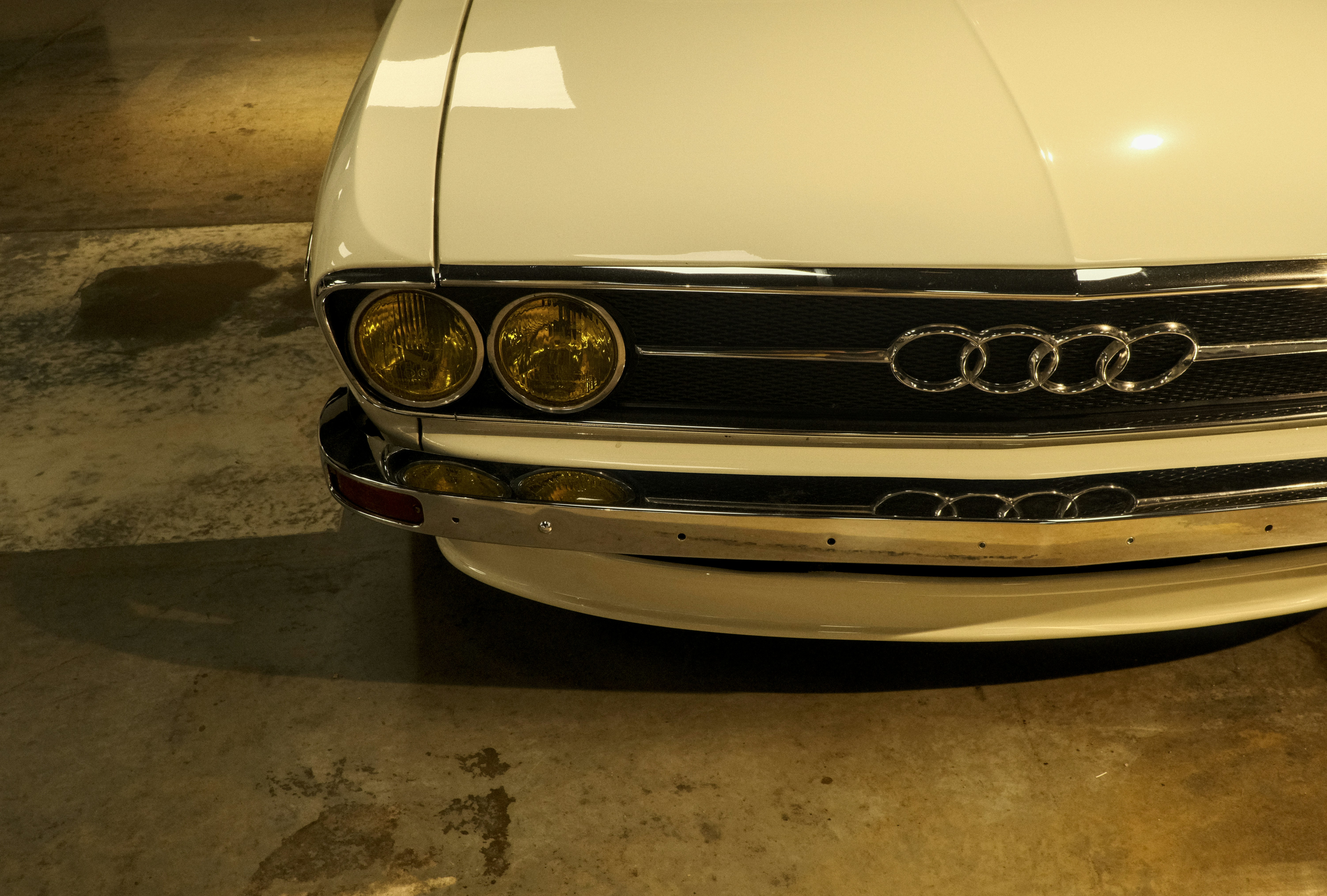 Close-up of a vintage white audi car grille.