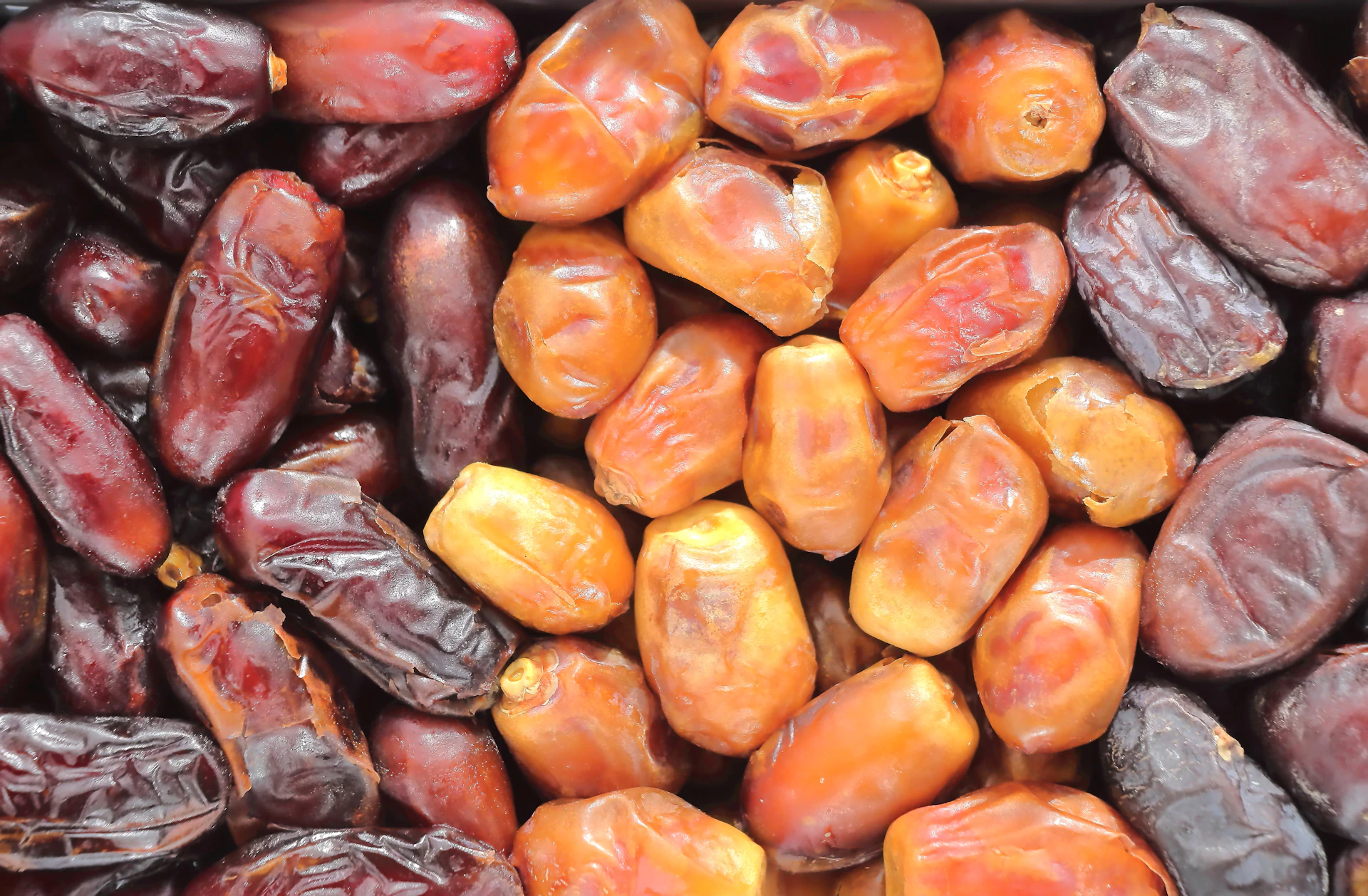 A pile of dried dates in various shades of brown.