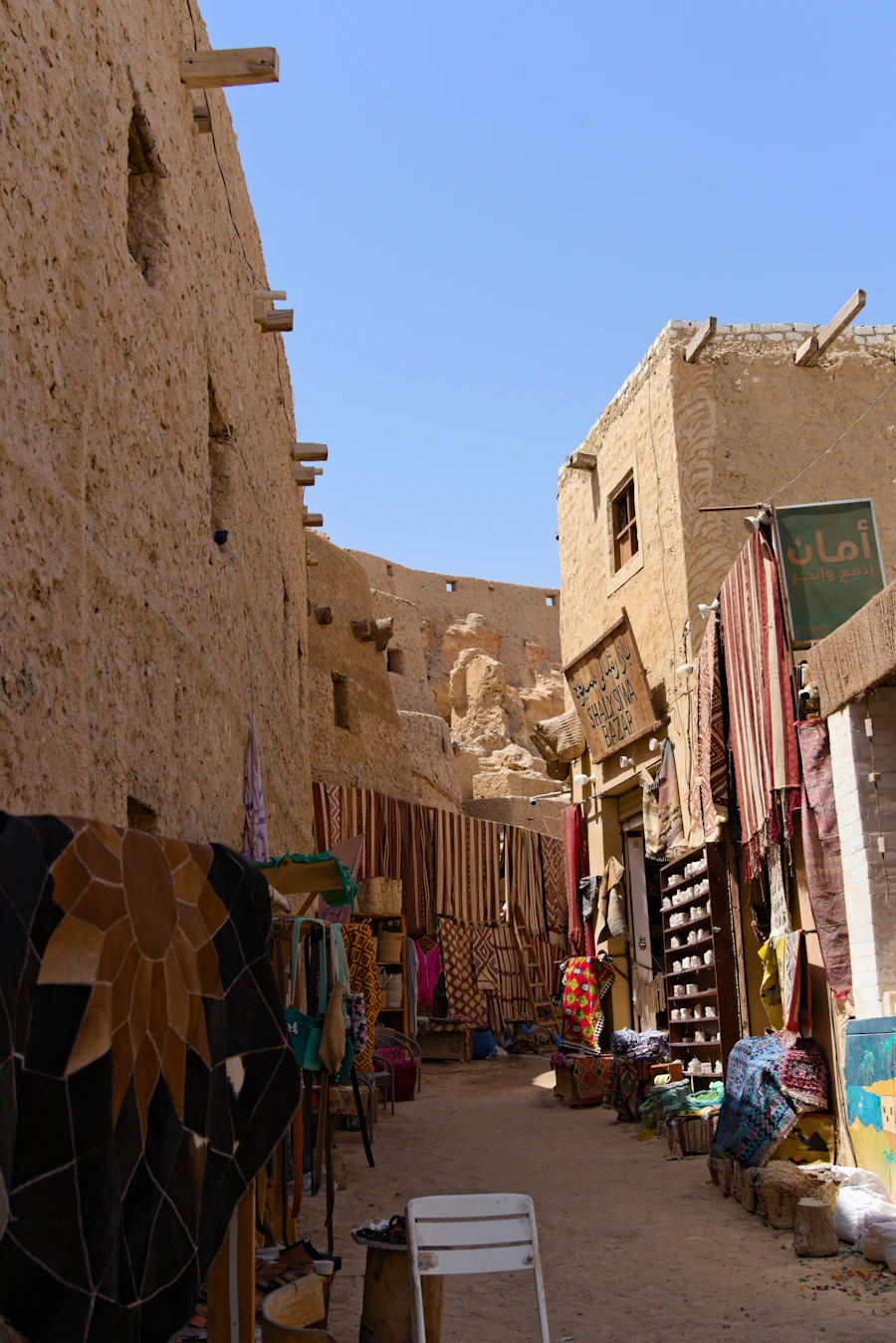 Siwa Oasis market alleyway with textiles