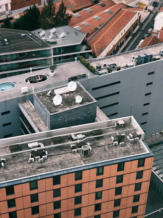 Rooftops of buildings in a city viewed from above.