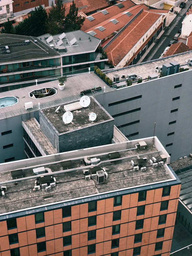 Rooftops of buildings in a city viewed from above.