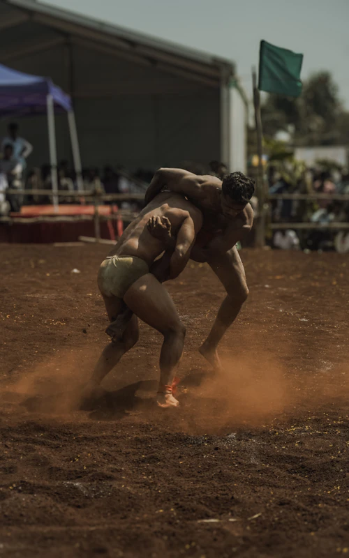 Players grappling during a kabaddi raid