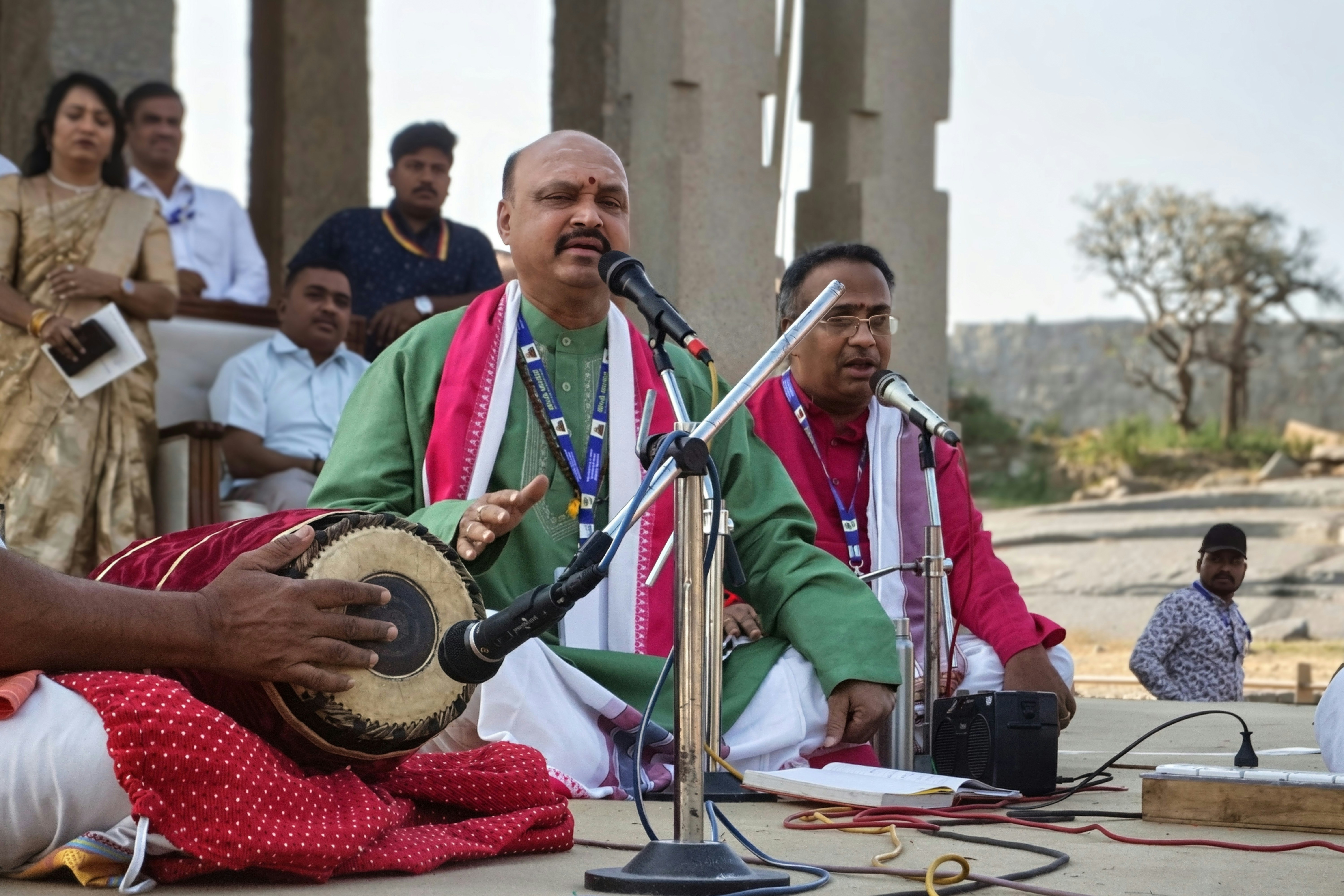 Musicians performing traditional indian music outdoors.