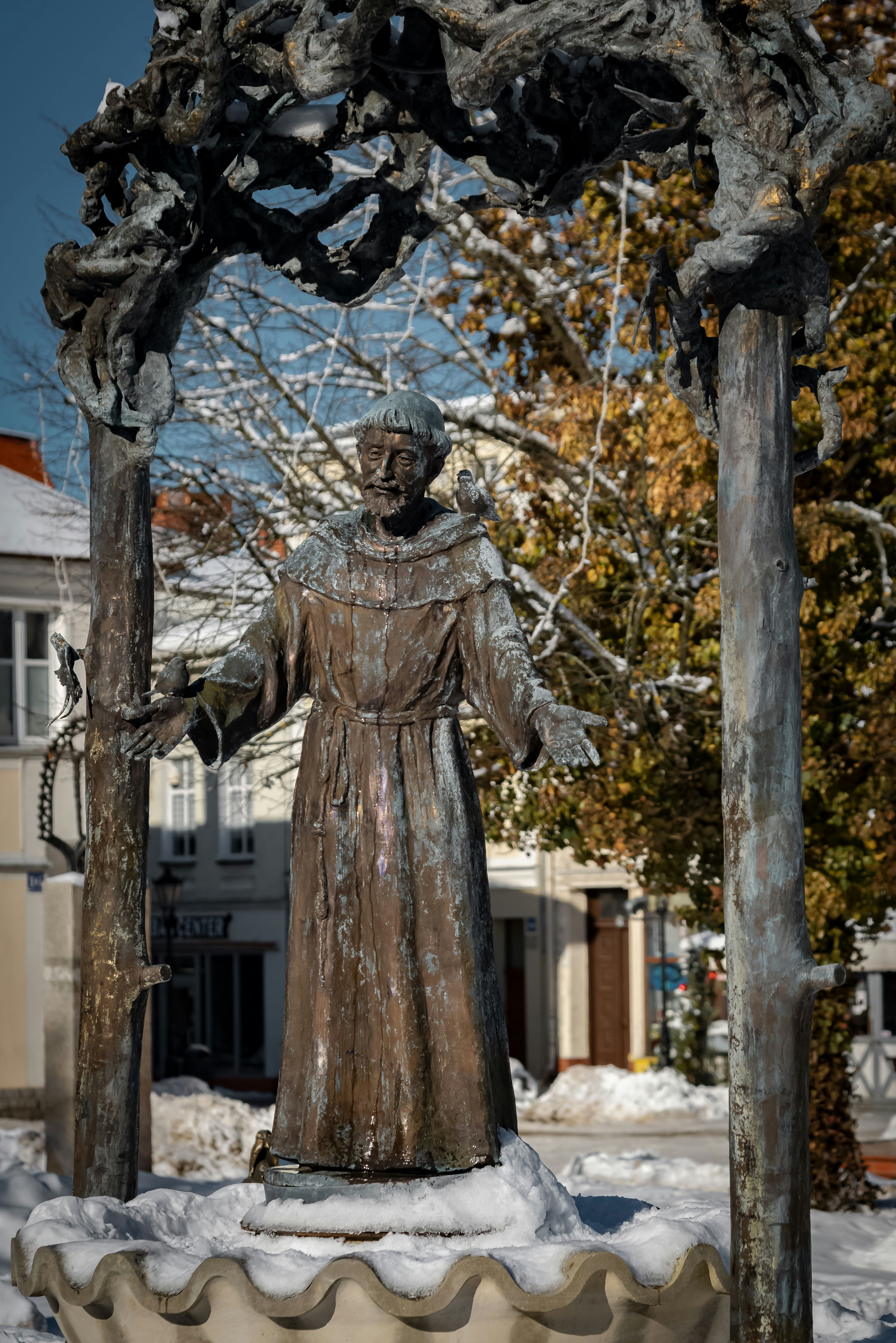 Bronze statue of a monk in a town square