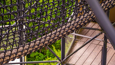 A close-up view of a rope bridge with wooden planks.