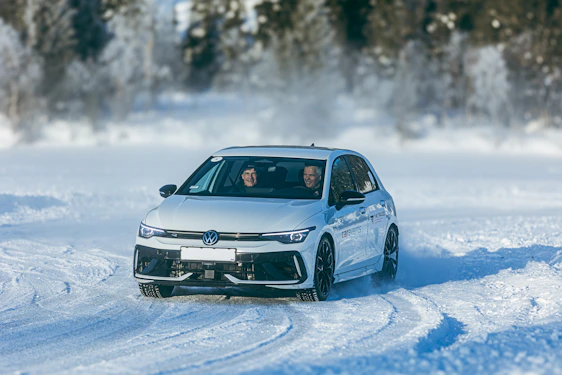 White car drifting on a snowy track