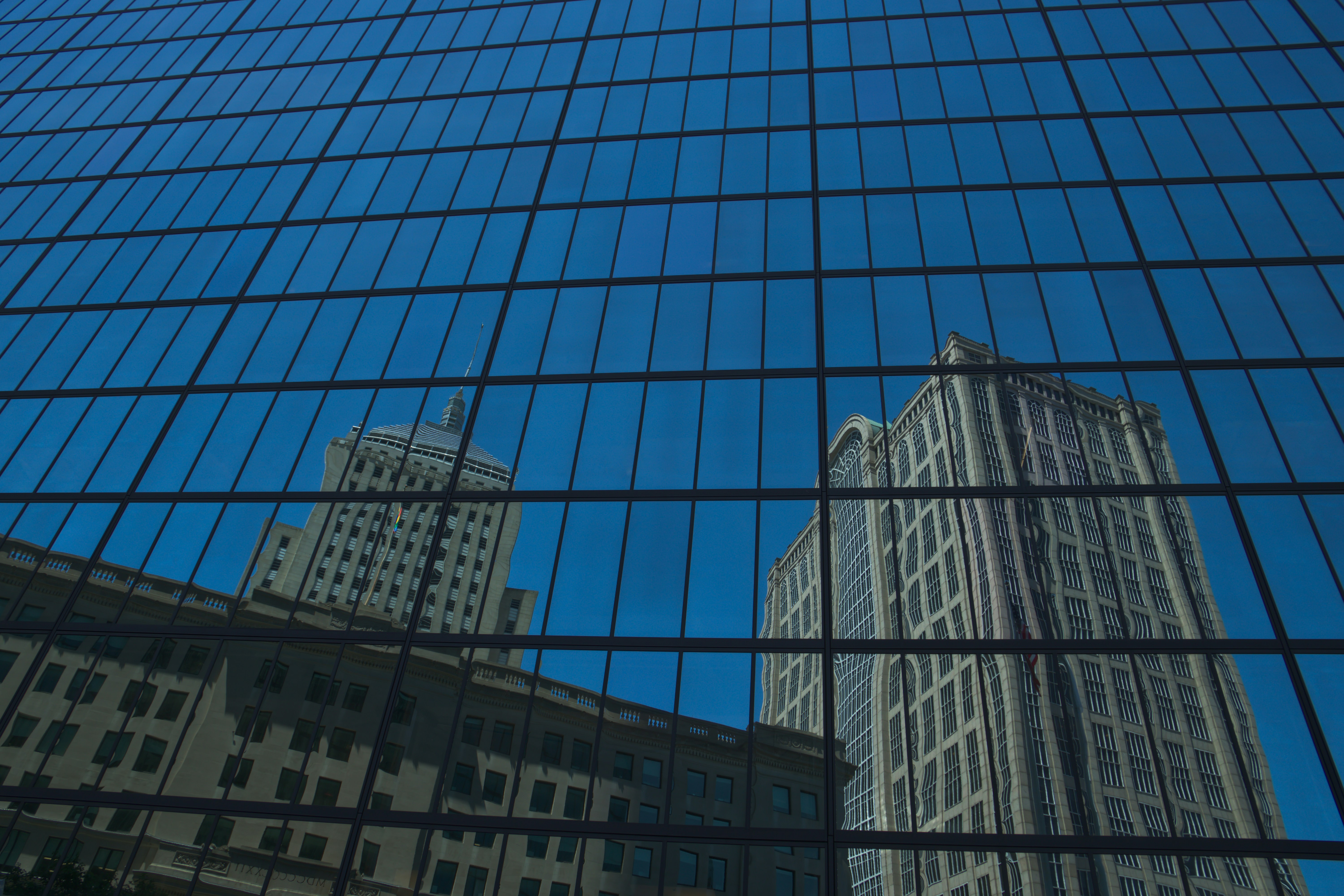 Reflection of buildings in a glass skyscraper facade