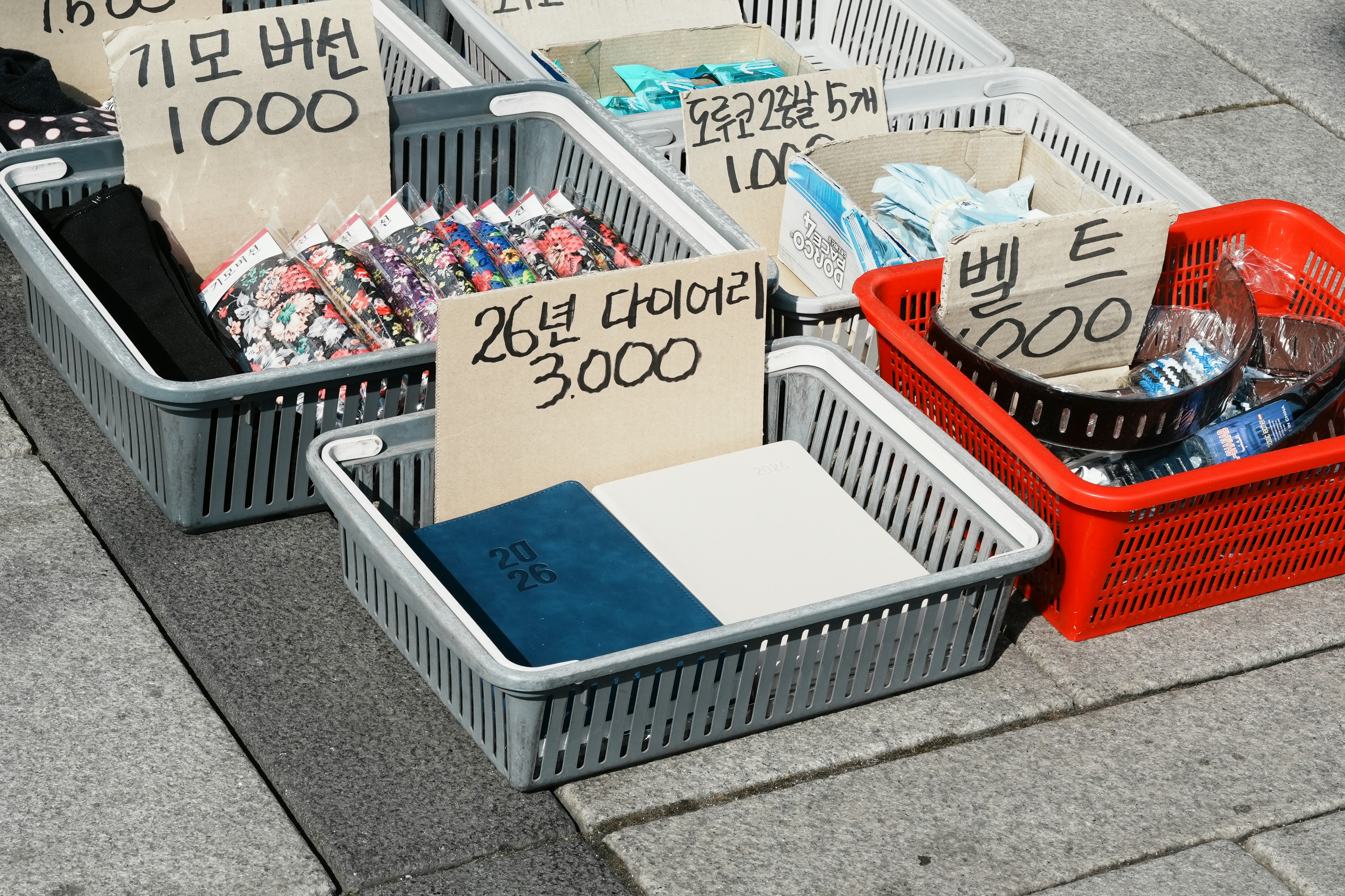 Baskets of goods with korean price tags on signs