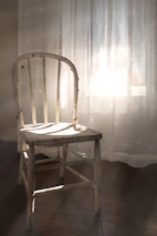 An old wooden chair bathed in sunlight