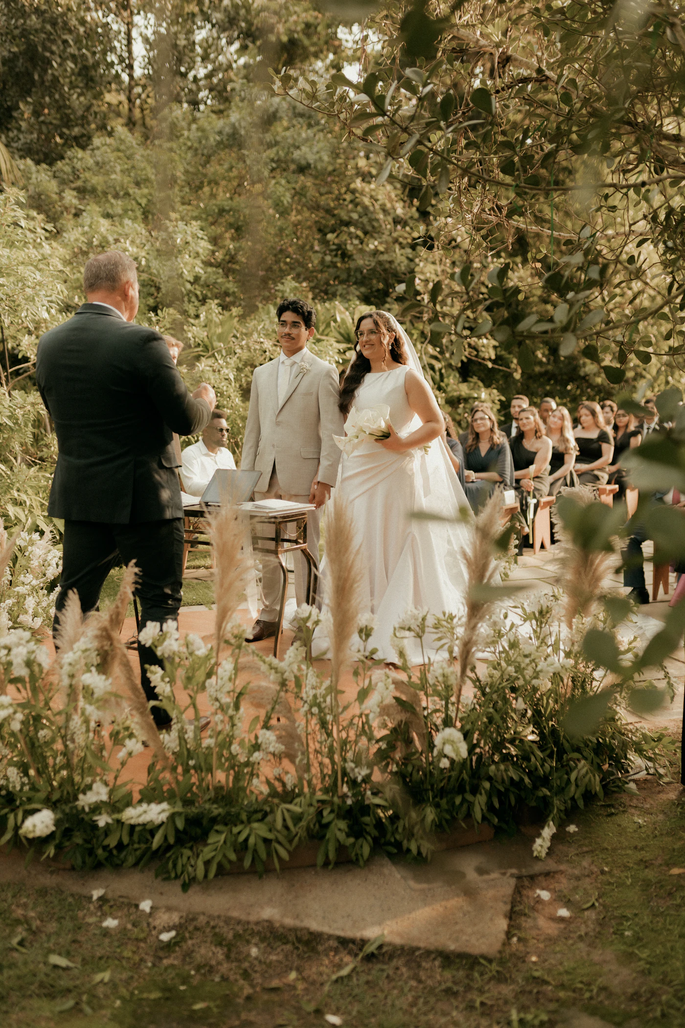 How to handle unexpected delays during ceremonies — A wedding coordinator checks a clipboard during an outdoor ceremony setup.
