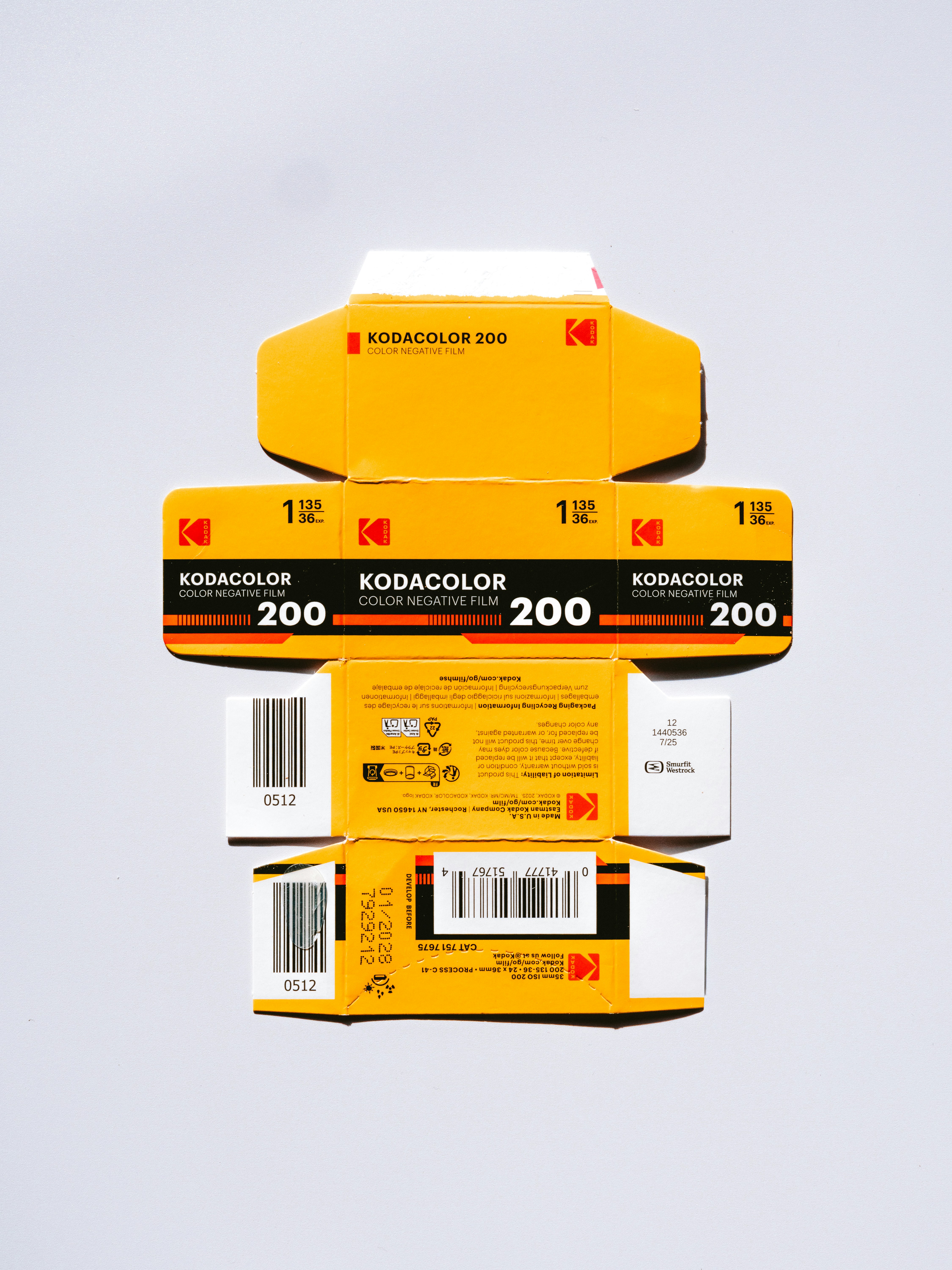 Stack of kodak color film boxes on white background