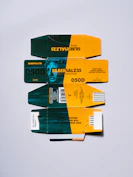 Four stacked film boxes with green and yellow designs.