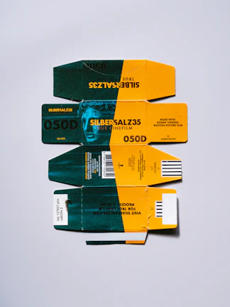 Four stacked film boxes with green and yellow designs.