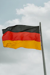 German flag waving against a cloudy sky