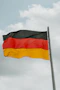 German flag waving against a cloudy sky