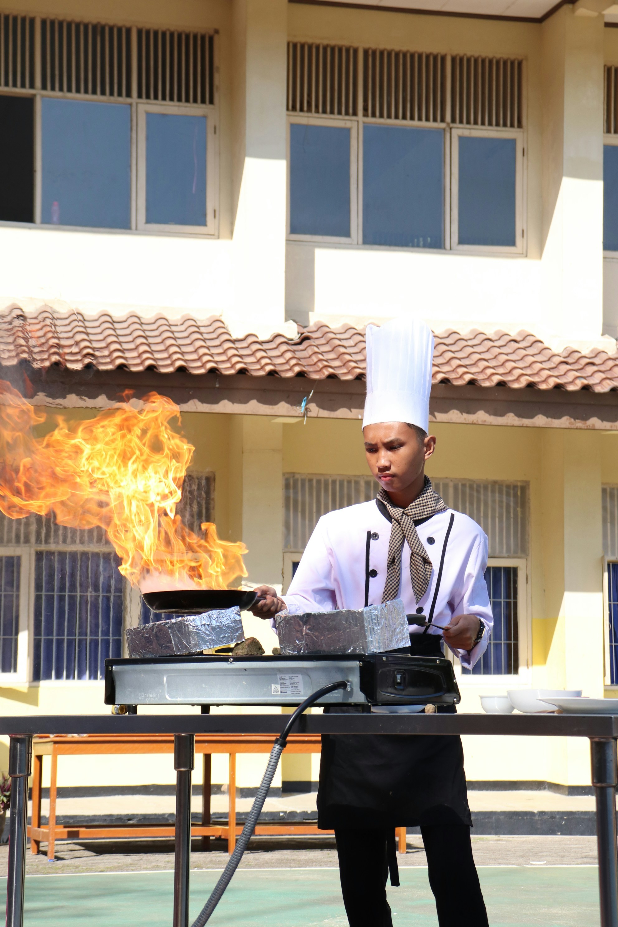 Chef cooking with large flames on a pan