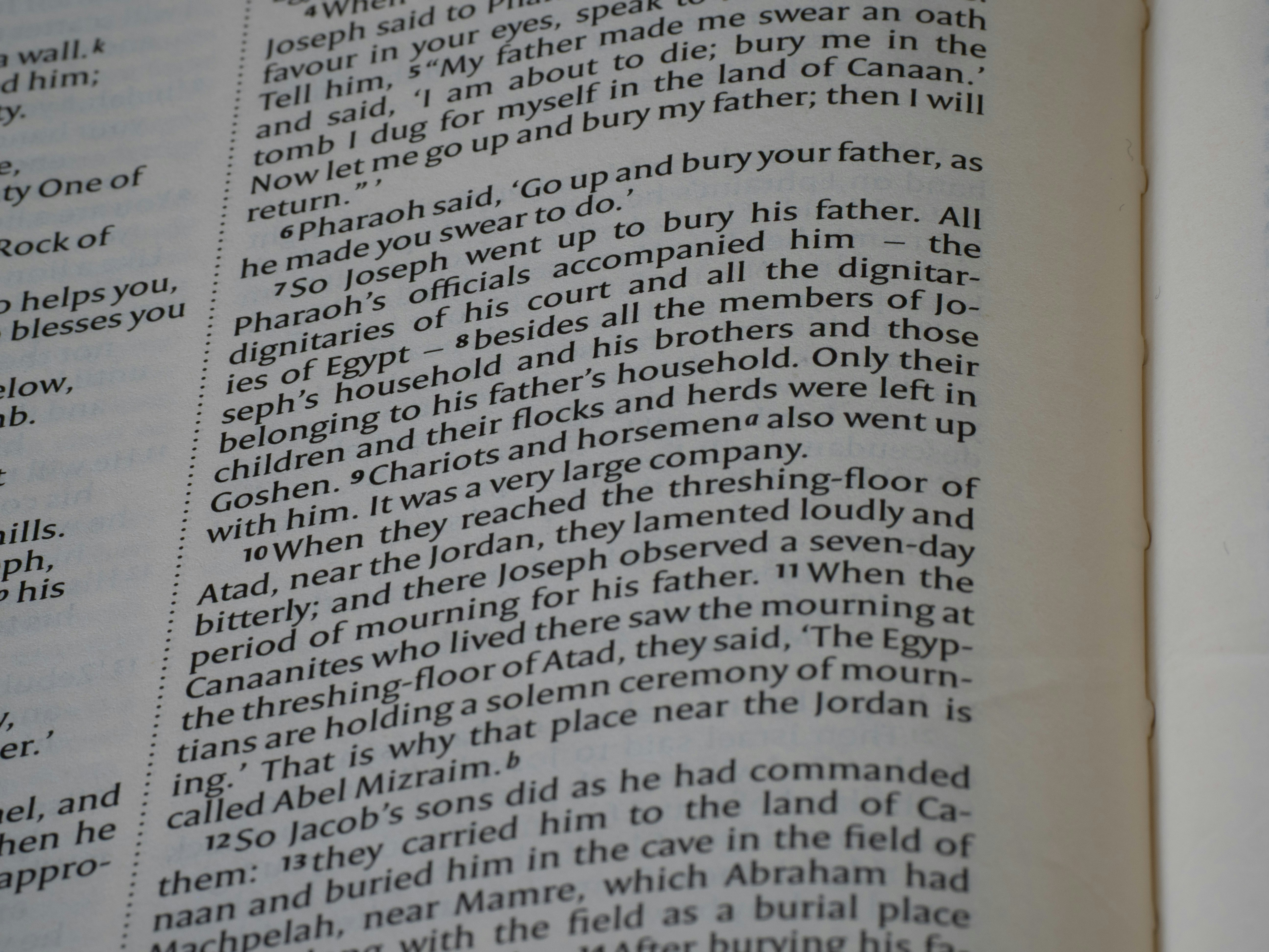 Close-up of open book with text on pages.